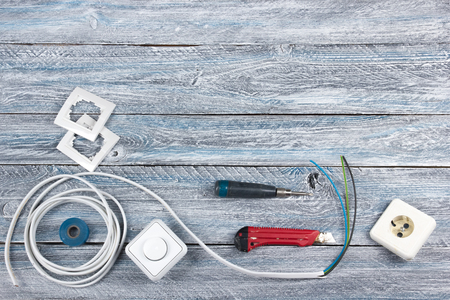 professional repairing implements for decorating and building renovation set on the wooden background, electrician. Electrical tools Top view. Copy space for text.の写真素材