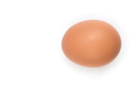 Single brown chicken egg isolated on white. Top viewの写真素材