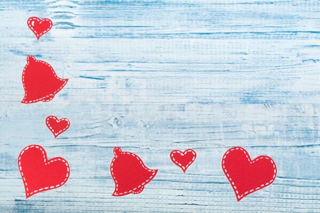 Red paper hearts on a wooden background. Valentines Day. Copy space. Top view.
