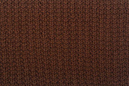 Sweater or scarf fabric texture large knitting. Knitted jersey background with a relief pattern....