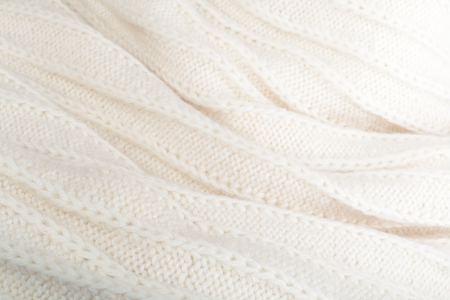 Sweater or scarf fabric texture large knitting. Knitted jersey background with a relief pattern....