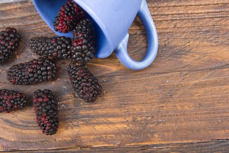 blackberries on wooden table background, spilled from a spice jar. .Antioxidants, detox diet, organic fruits. Berriesの写真素材