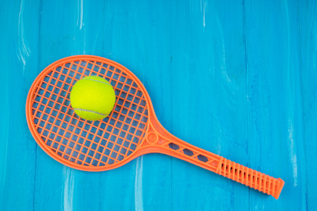 Tennis rackets and ball on blue wooden background.の写真素材