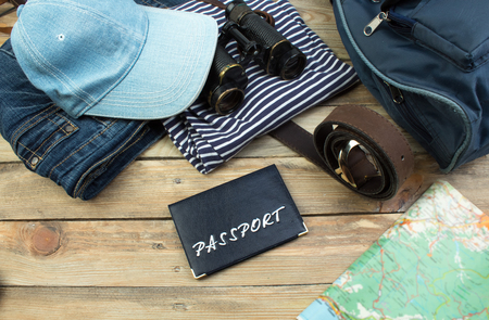 Travel concept on wooden table. Top view image of travel accessories with washed out vintage filter effect.の写真素材