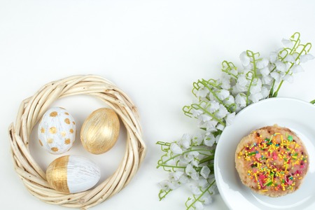 Happy Easter. Painted eggs on white background. Easter Cake - Russian and Ukrainian Traditional...
