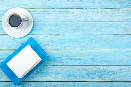 Blue office desk table with computer, pen and a cup of coffee, lot of things. Top view with copy space.の写真素材