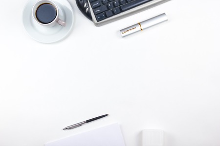 White Office desk table with computer, pen and a cup of coffee, lot of things. Top view with copy spaceの写真素材