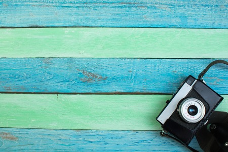camera on Wooden Background - Beach Summer Holiday. Top view and copy space.