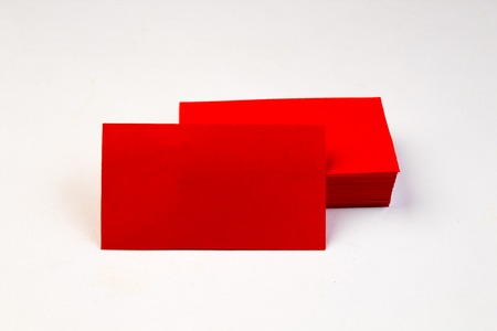 stack of red blank business cards on white background.の写真素材