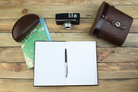Travel accessories. Passports, luggage, The of travel maps prepared for the trip. Top view image accessories with washed out vintage filter effect.の写真素材