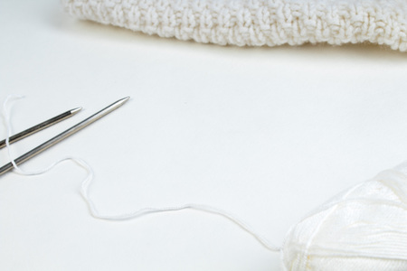 Pair of knitting needles isolated over white. Sweater or scarf White Crocheted Fabric Texture. Knitted jersey background with a relief pattern. Wool hand- machine, handmadeの写真素材