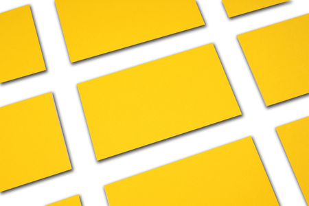 Mockup of horizontal gold business cards stacks arranged in rows at white background