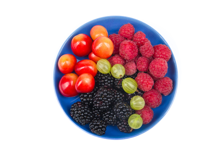 Various summer Fresh berries in a bowl on rustic wooden table. .Antioxidants, detox diet, organic fruits. Top viewの写真素材