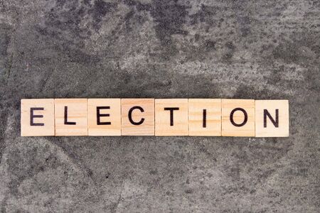 Election word written on wood block, on gray concrete backgroundの写真素材