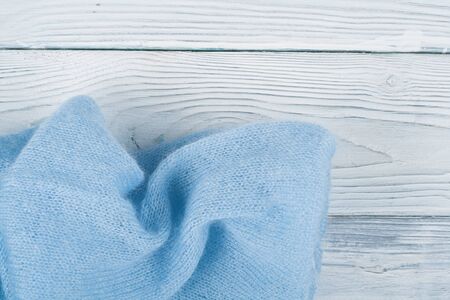 Sweater or scarf fabric texture large knitting. Knitted jersey background with a relief pattern. Wool hand- machine, handmade, blue.の写真素材