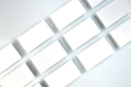 Mockup of horizontal business cards stacks arranged in rows at white textured paper background.の写真素材