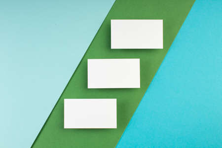 Business card blank over colorful background. Copy space for text. Top view.Business card blank over colorful abstract background. Corporate stationery branding mock-up. Copy space for text. Top view.の写真素材