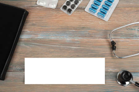 Health care template for text medicine treatment concept. Empty blank, stethoscope, prescription medical help emergency, healthy ambulance technology on wooden table. Copy space for text.の写真素材