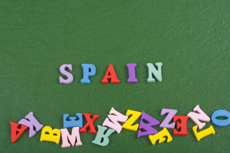 SPANISH word on green background composed from colorful abc alphabet block wooden letters, copy space for ad text. Learning english concept.の写真素材