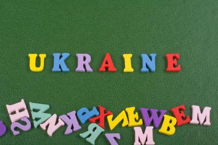 UKRAINIAN word on green background composed from colorful abc alphabet block wooden letters, copy space for ad text. Learning english concept.の写真素材