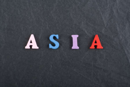 ASIA word on black board background composed from colorful abc alphabet block wooden letters, copy space for ad text. Learning english concept.の写真素材