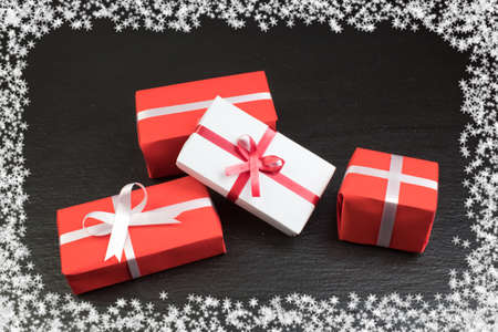Gift boxes and colorful present for christmas on blackboard. Top view with copy space.の写真素材