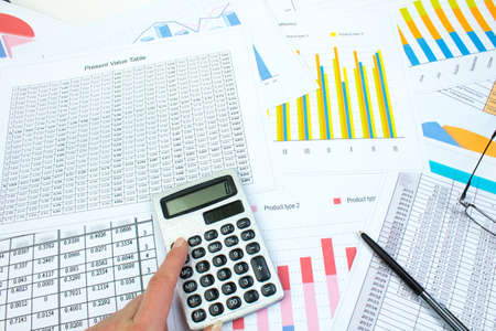 Financial printed paper charts, graphs and diagrams on the table. Top view