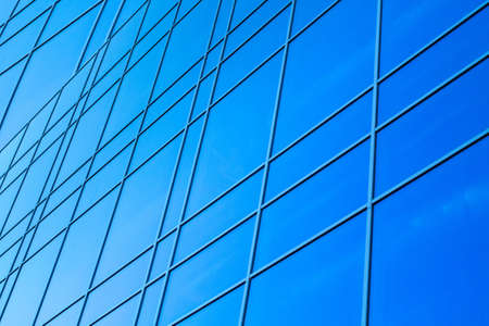glazed facade. glazed facade against a blue background. modern skyscrapers of downtown.