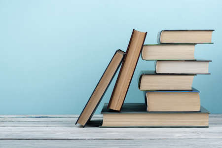 Stack of colorful books. Education background. Back to school. Book, hardback colorful books on wooden table. Education business concept. Copy space for text.の写真素材