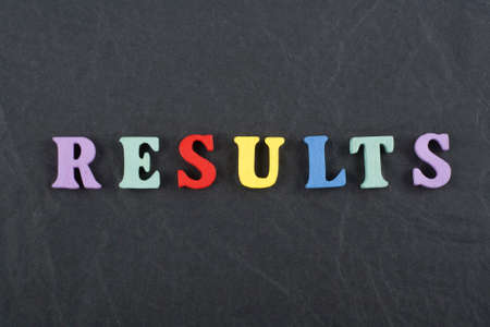 RESULTS word on black board background composed from colorful abc alphabet block wooden letters, copy space for ad text. Learning english concept.の写真素材