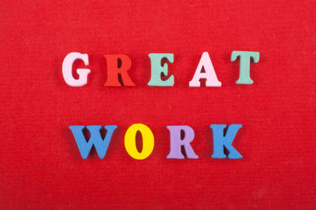 GREAT WORK word on red background composed from colorful abc alphabet block wooden letters, copy space for ad text. Learning english concept.の写真素材