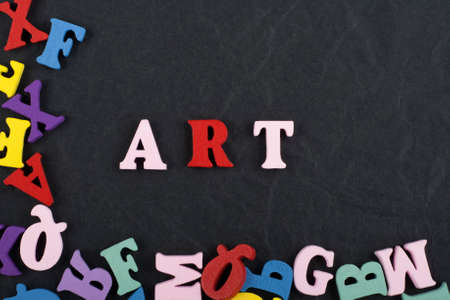 ART word on black board background composed from colorful abc alphabet block wooden letters, copy space for ad text. Learning english concept.の写真素材