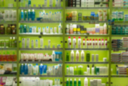 Blur image rows of hair care products on display at store. Cosmetic Products For Sale In Beauty Department store abstract background.の写真素材
