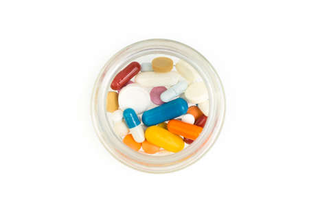 Pills pouring out of the brown bottle.