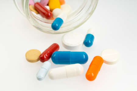 Set of different colorful pills and capsules isolated on white background.の写真素材