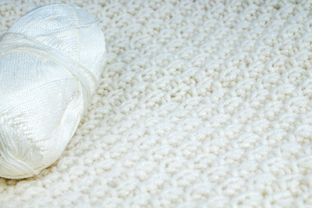 Sweater or scarf fabric texture large knitting. Knitted jersey background with a relief pattern....