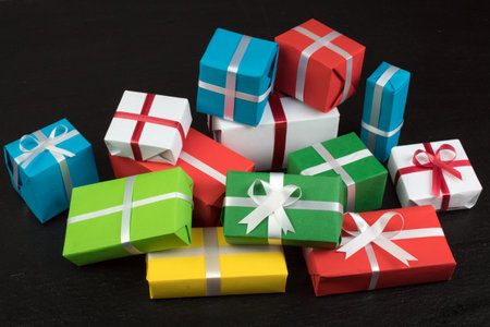 Gift boxes and colorful present for christmas on blackboard. Top view with copy space.の写真素材