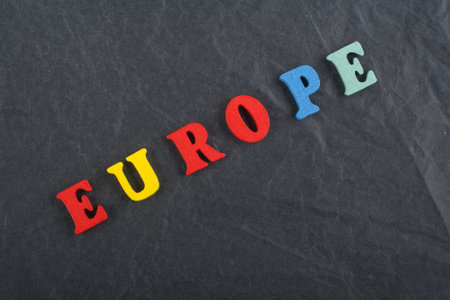 EUROPE word on black board background composed from colorful abc alphabet block wooden letters, copy space for ad text. Learning english concept.の写真素材