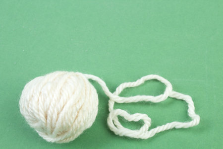 Knitting yarn for knitting on green background.の写真素材