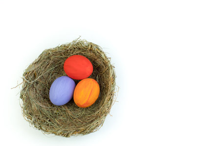 happy easter. Top view of nest with colorful eggs, isolated on white background. Copy space for textの写真素材