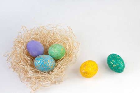happy easter card. Colorful shiny eggs in a nest isolated on a white background. Copy space for textの写真素材