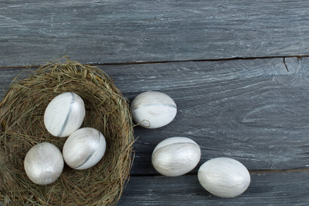 Happy Easter. Top view nest with Painted eggs on wooden table. Copy space for textの写真素材