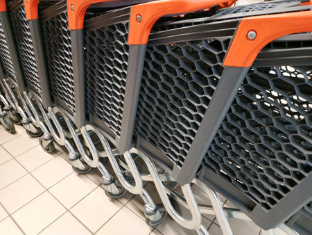 row of empty shopping carts in the big supermarketの写真素材