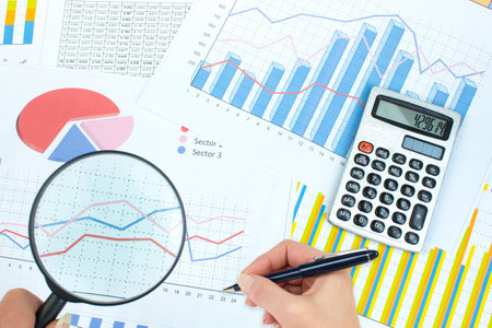 Financial Charts, graphs, coins, calculator on isolated white background. Top view with copy space.の写真素材