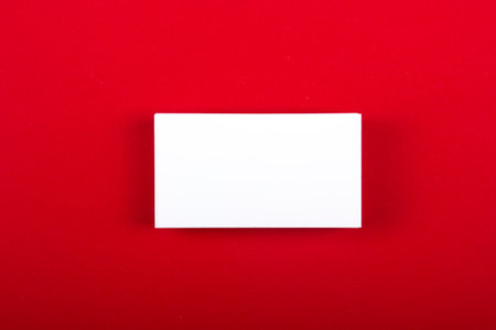 Blank business cards at red textured background. Template for ID. Top view.の写真素材