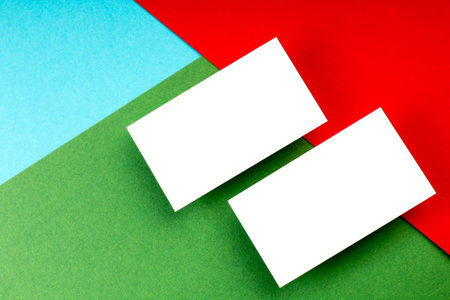 Business card blank over colorful background. Copy space for text. Top view.Business card blank over colorful abstract background. Corporate stationery branding mock-up. Copy space for text. Top view.の写真素材