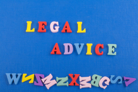 LEGAL ADVICE word on blue background composed from colorful abc alphabet block wooden letters, copy space for ad text. Learning english concept.の写真素材