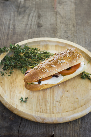 Healthy sandwich on round wooden plateの写真素材