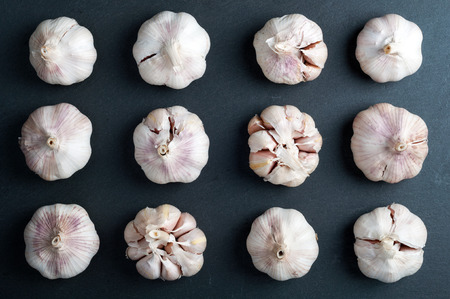 Garlic background. Garlic on a stone background. Top view