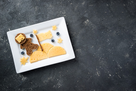 Funny toast with cheese and berries for kids breakfast or lunch.  Children's breakfast with creative...